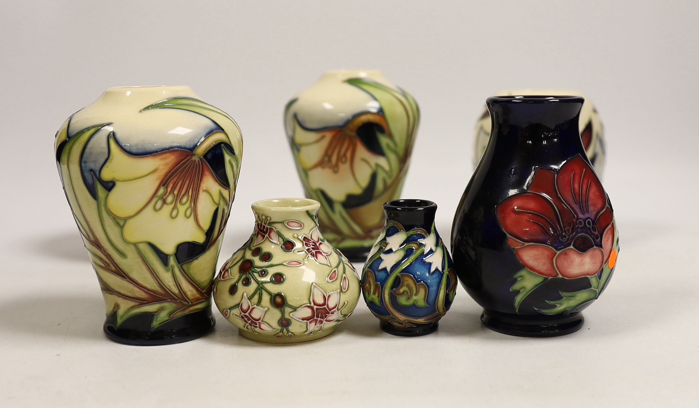 Seven small Moorcroft vases, various patterns. Tallest 10cm